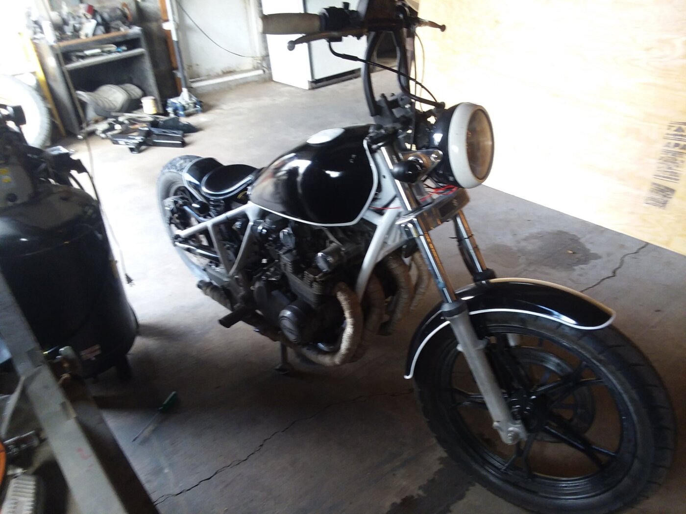 A black motorcycle parked inside the garage.