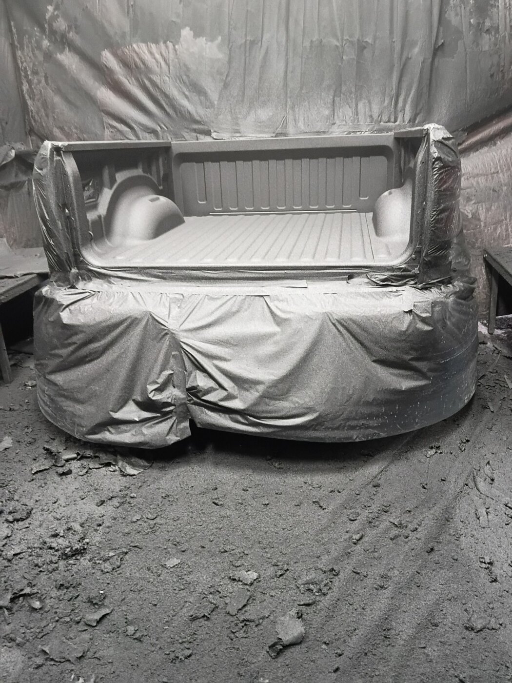 A pickup bed masked for body and surface work.