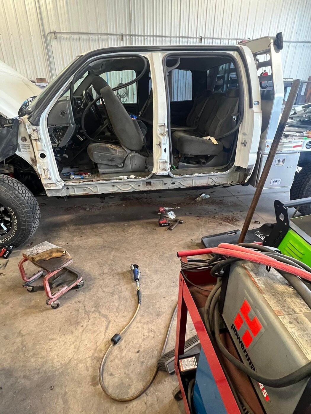 A pickup cab with seats and interior trim removed.