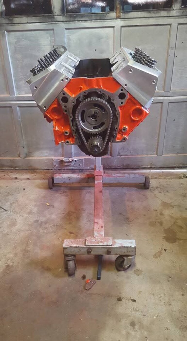 A V8 engine assembly photographed from the front on an engine stand.