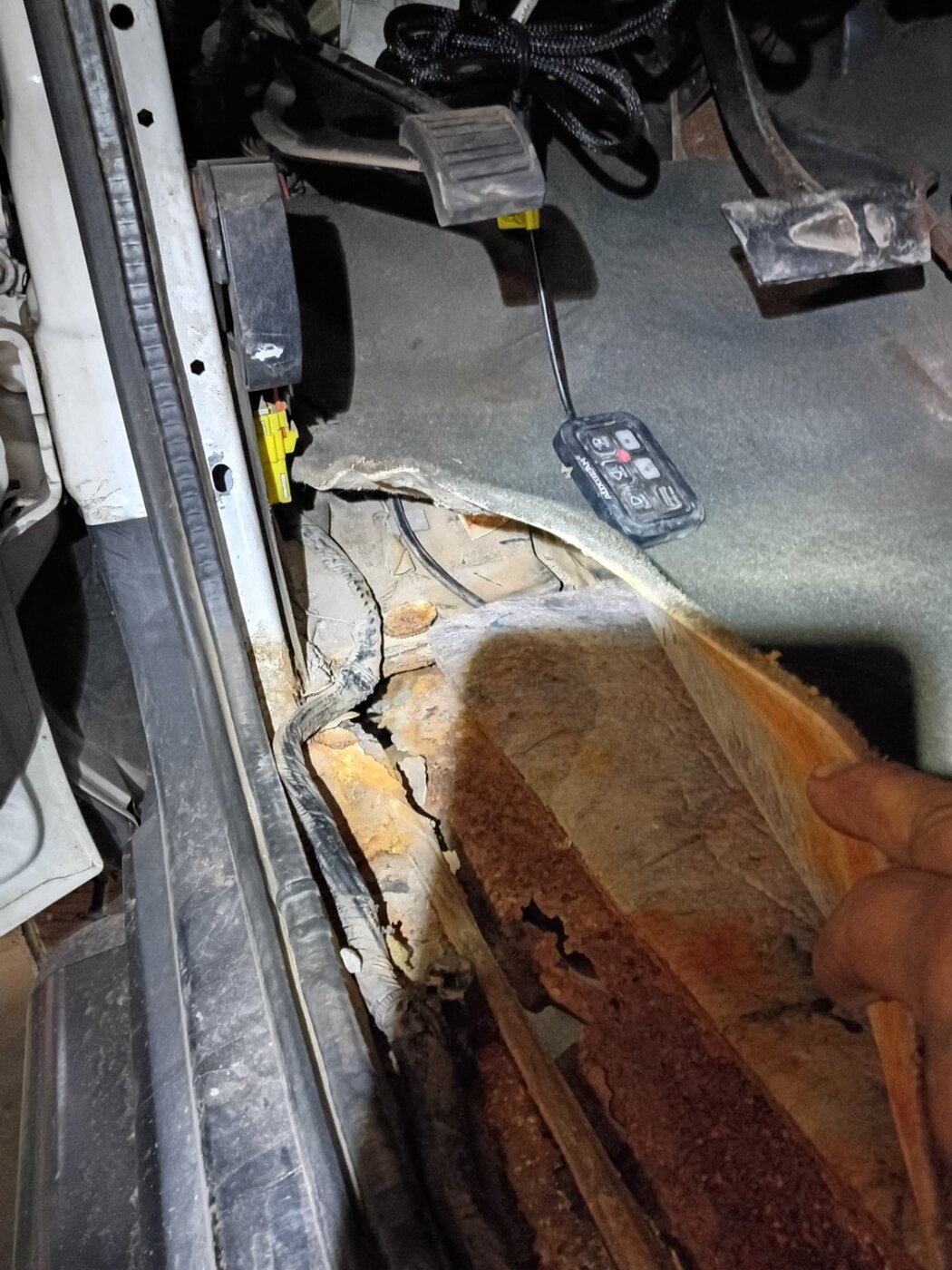 An exposed vehicle floor panel showing surface condition.