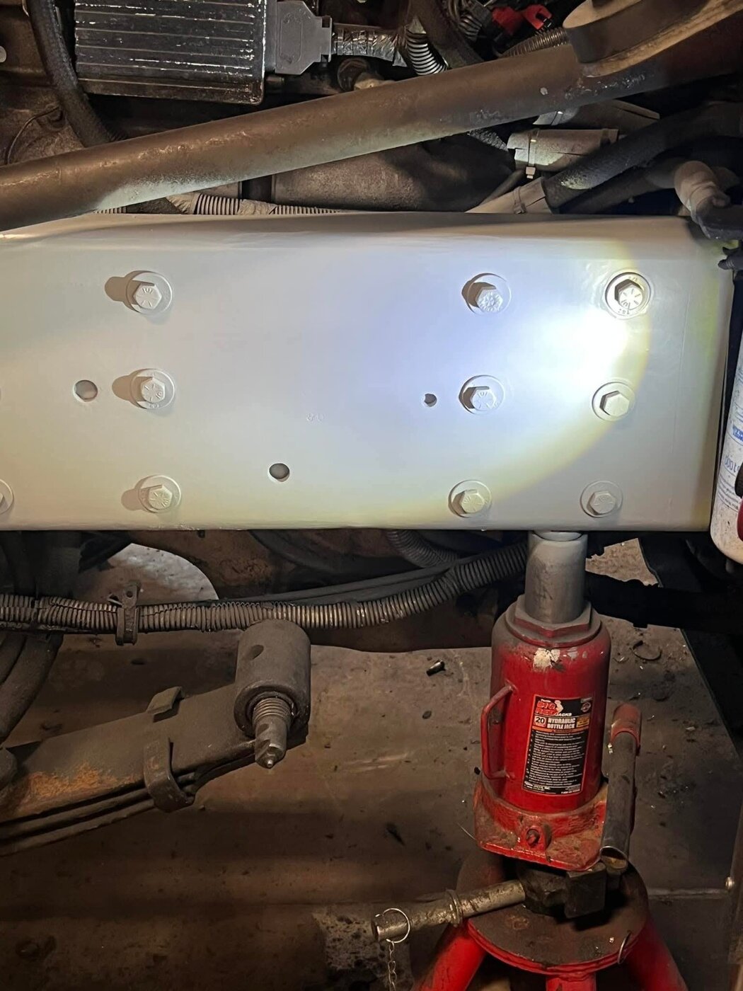 A close view of a truck frame surface during workshop work.