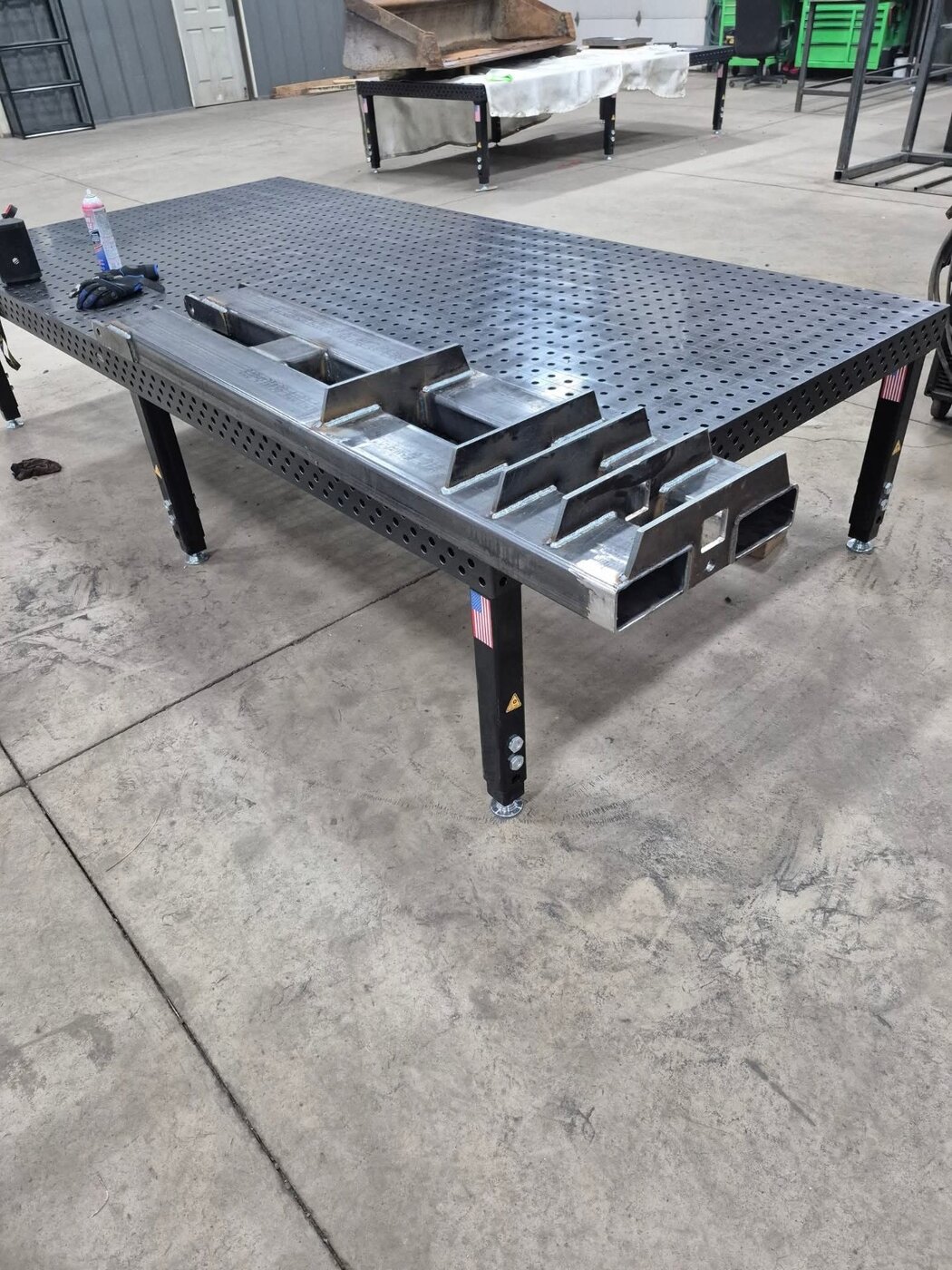 A steel platform with a diamond-plate deck in the workshop.