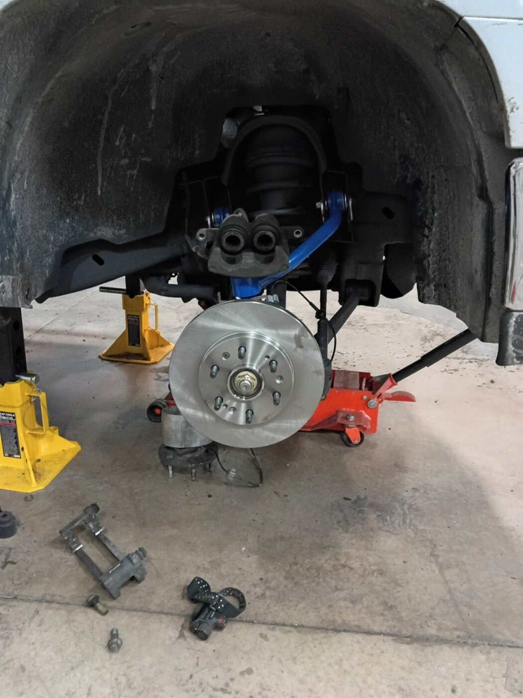 A close view of an exposed wheel hub and suspension assembly.