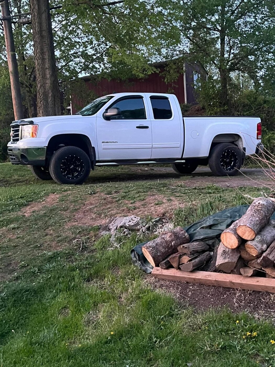 A white extended-cab pickup photographed outside.